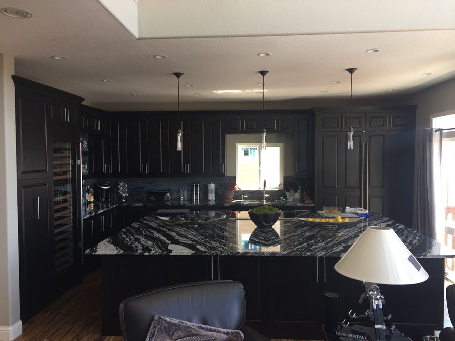 Matte black kitchen with veined stone island
