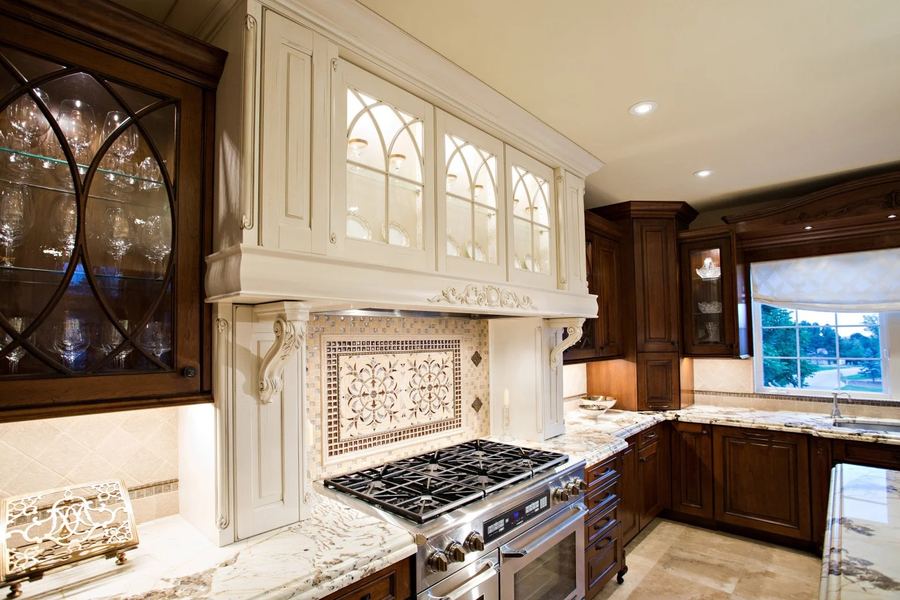Custom cream hood with lit glass cabinets