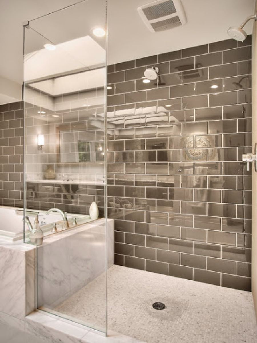 Glass shower with dark horizontal subway tile