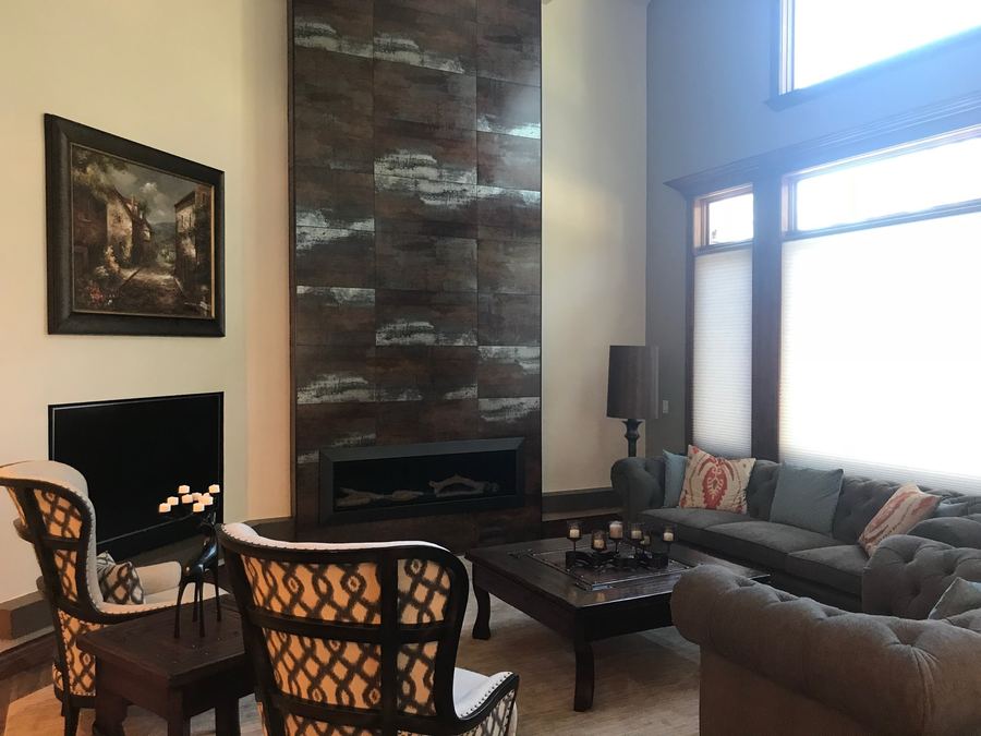 Floor-to-ceiling tile fireplace wall