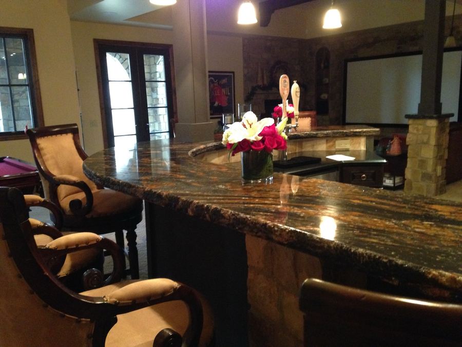 Curved granite wet bar in finished basement